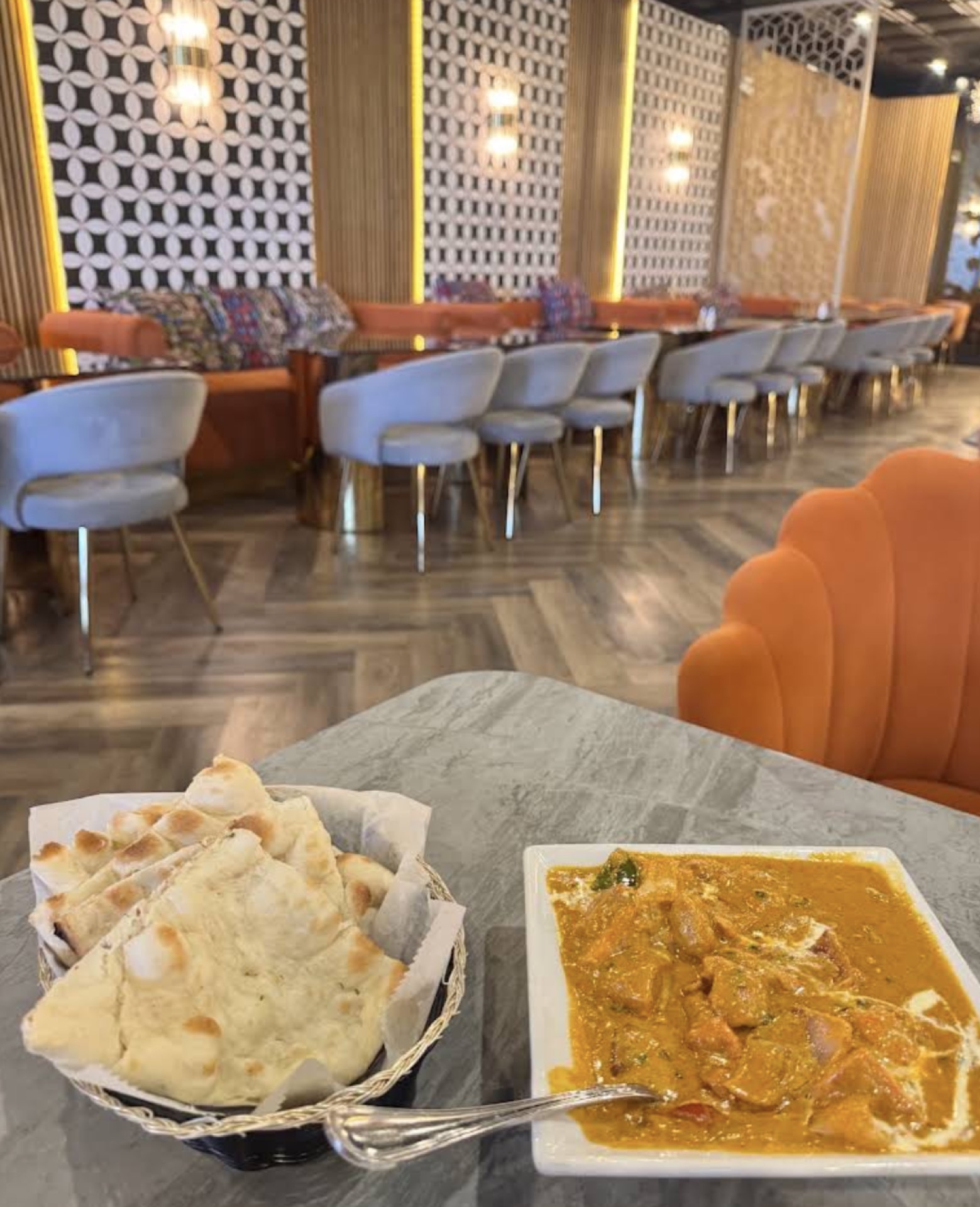 Naan and curry with the dining room in warm focus behind