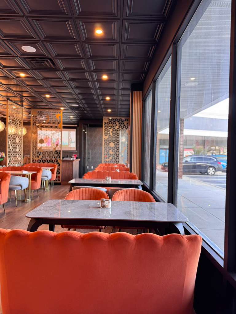 Orange scallop booths along floor-to-ceiling windows